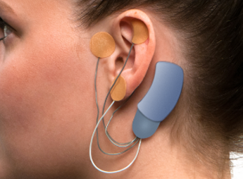 Person wearing Masimo Bridge device applied to their ear.